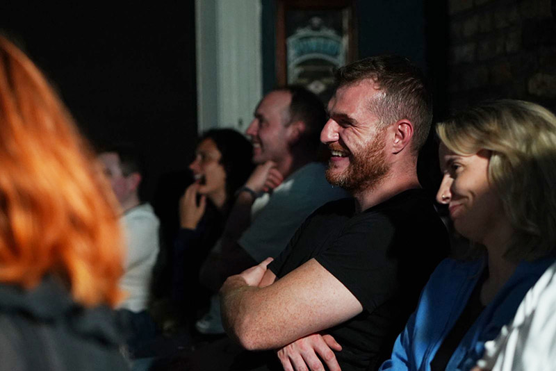 Audience members laughing at a Crash & Burn Show